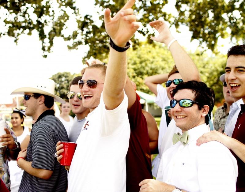 Members of Pi Kappa Alpha eagerly wait in line for their Tiger Tailgate tanks provided by Trinity University Cheer. The Pikes initiated school spirit by tailgating all day before the kick-off.