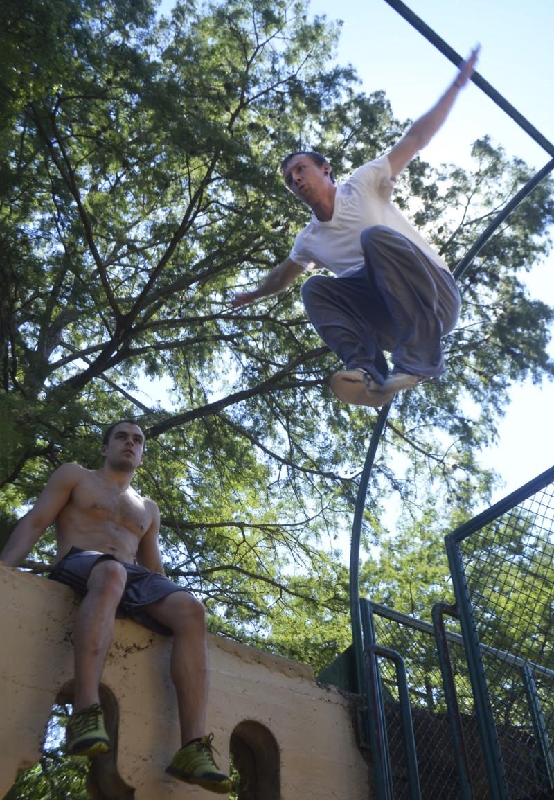 Trinity alumni Mike Avery (left), along with a fellow member of Texas Parkour, showcase their high-flying abilities in Brackenridge Park. Photo by Paul Cuclis.