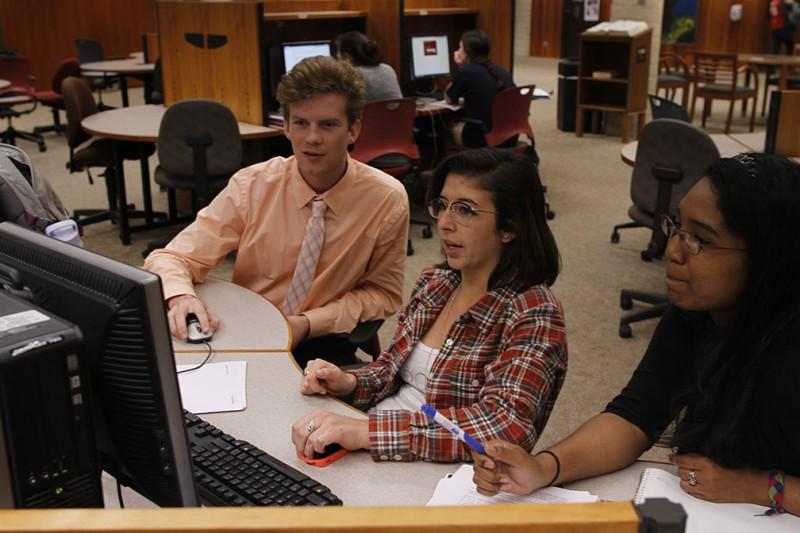 (Left to Right) Seniors Shane Lannan, Sophie Laster-Hazzard and Alana Ramos gather in Coates Library to work on a group project for their marketing management class. Photo by Aidan Kirksey.