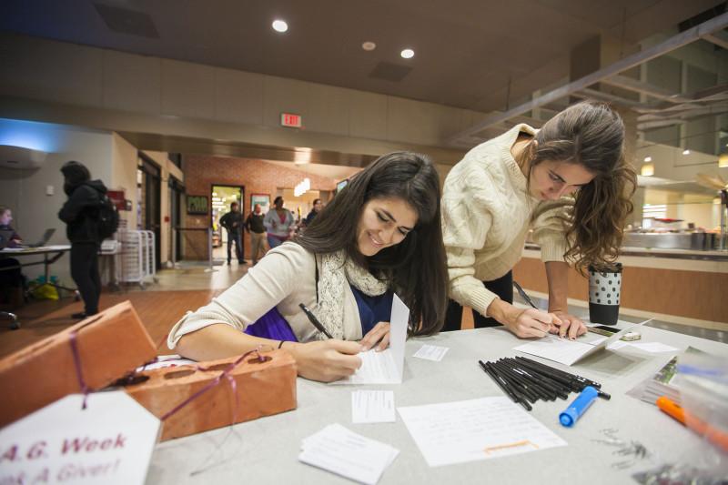 Jessica Avilez (Jr). Erika Migeon (SO). Writing thank you letters to those who donate to Trinity University during Student Ambassadorâ€™s T.A.G. (Thank A Giver) Week event. Photo by Anh-Viet Dinh.