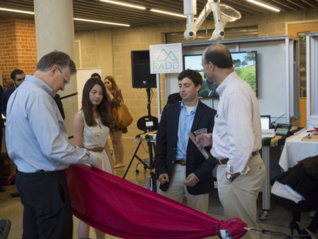 Photo by Henry Pratt.
 Sarah Forin and Jamie Procter discuss the details of the lightweight, portable hammock as they promote their business, RADD, with guests at the Stumberg Competition.
