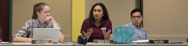 Senators Callie Struby, Amulya Deva and Isaiah Mora engage in discussion at a meeting. photo by Chloe Sonnier