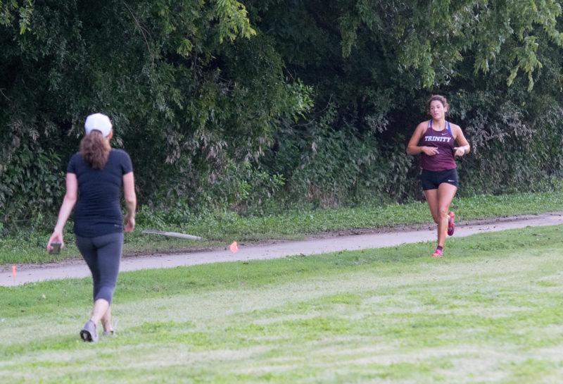 Cross country coach Emily Daum encourages first-year Mabel Fowler to push to the end of the race. photo by Allison Wolff