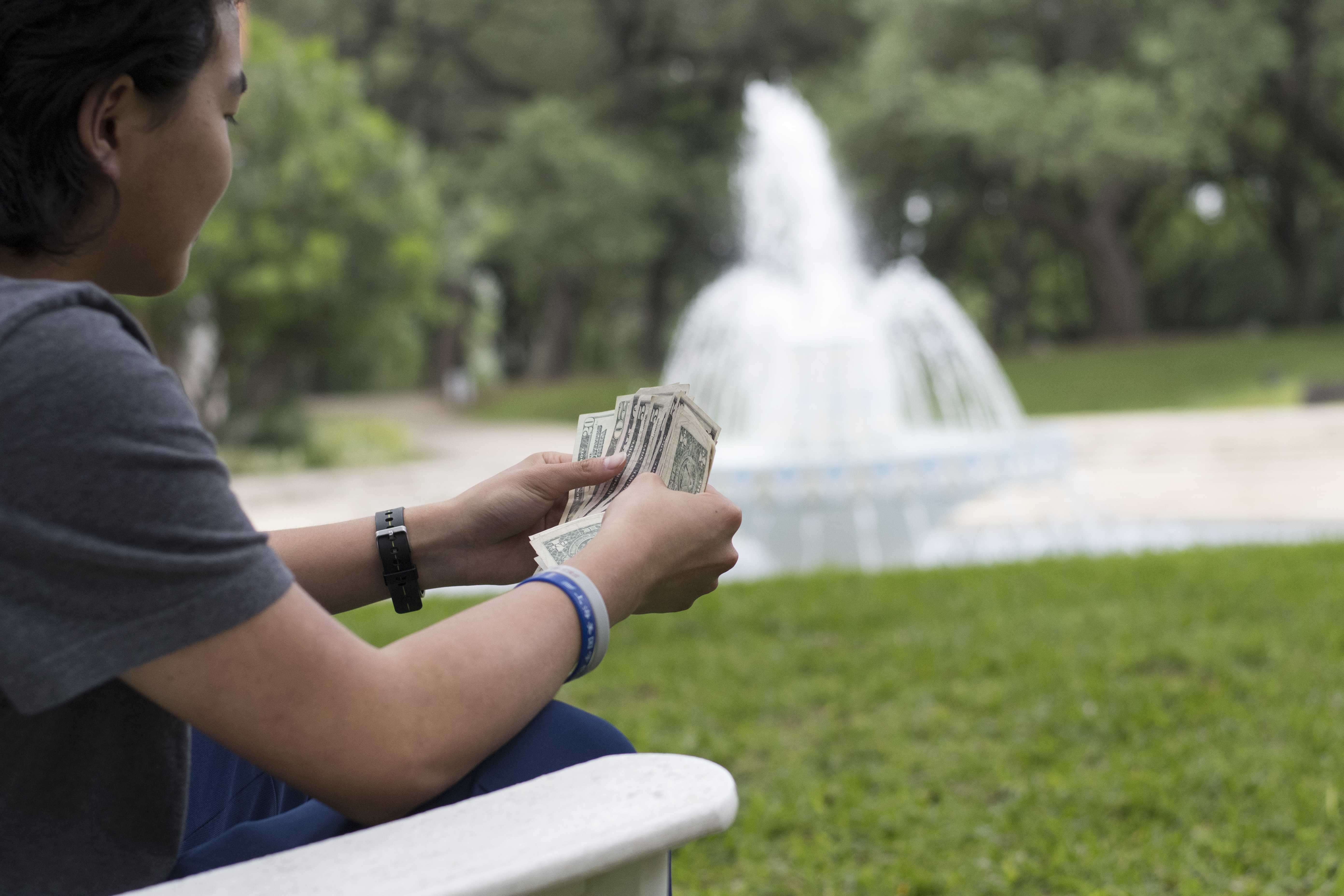 Strategic Communications and Marketing pays students for studying by fountain