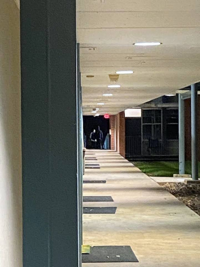 Unidentified men walk away from the lower level of Calvert Hall on the night of November 11th.
