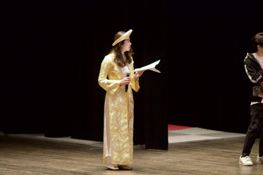 Senior Thao Dinh waits to read her script at the LNY dress rehearsal. 