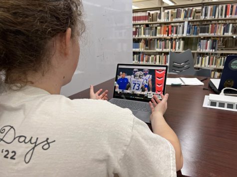 Student streaming first Brahmas game while in library