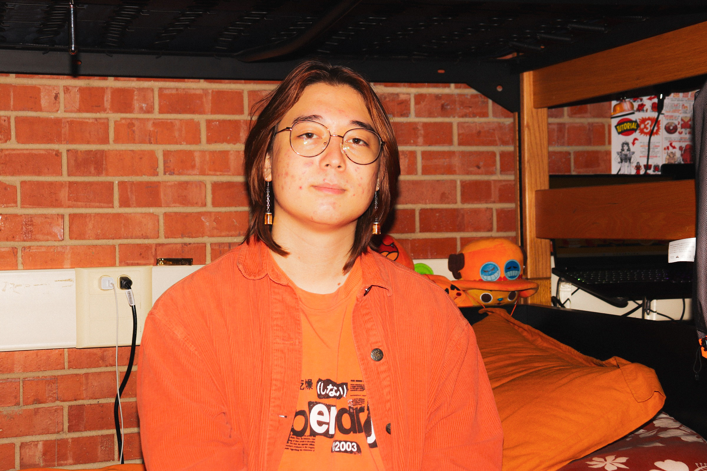 First-year James Lee always don orange   on campus, and his room is just as orange.