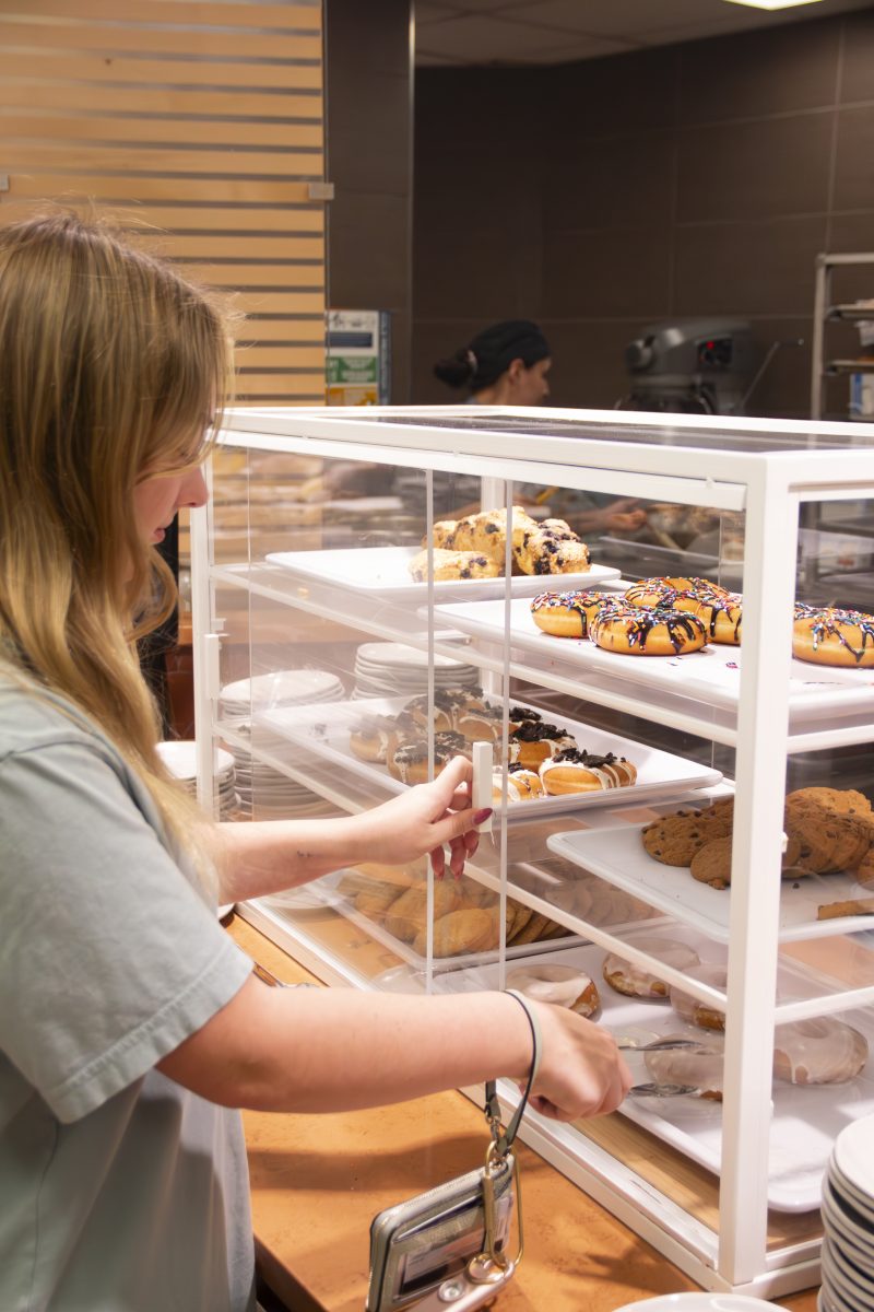 Sophomore Livy Charlesworth takes food from dining area