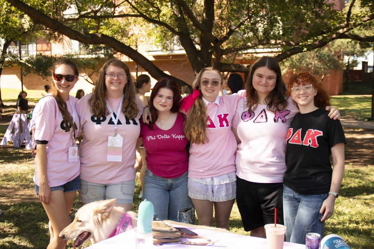 Phi Delta Kappa alumni and actives gather for group photo at Trinity Tailgat