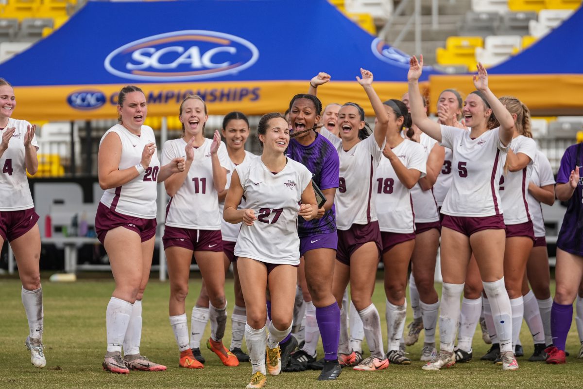 Senior forward Michaela Bosco celebrates with her team after scoring the winning goal against TLU.