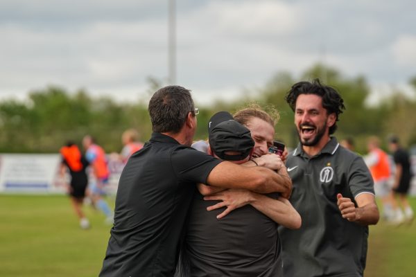 Trinity captain JC Rule embraces head coach Paul McGinlay.