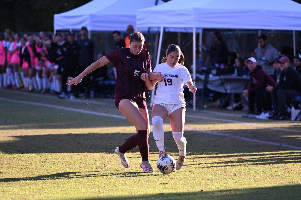 Defender Maggie Hartnett tries for a steal against California Lutheran midfielder Angelica Hernandez.