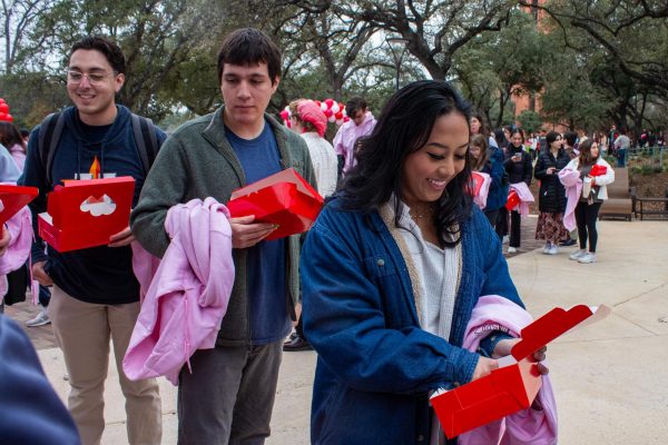 Students enter Chocolate Fest with heart boxes after waiting in a long line.