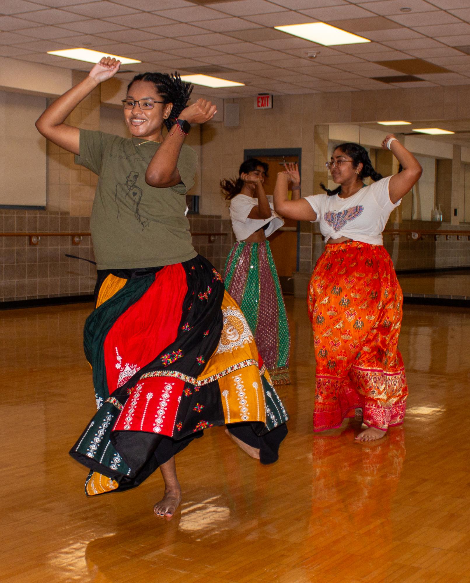 SASA members Taylor Hervey, Neela Ramanand Kavni Maniar practice their performance for Navratri. The event will start at 5:30 pm on Sep. 26 on the IM field.