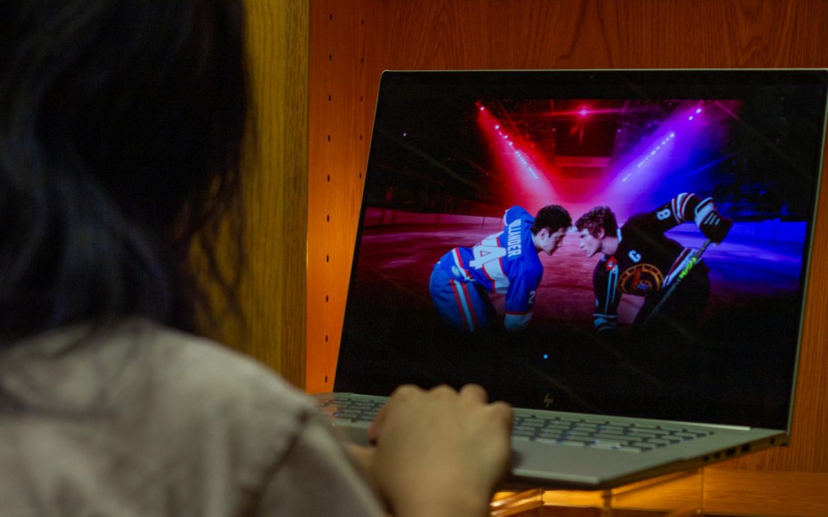 A student watches the Heated Rivalry trailer on their laptop. The show, which is available to watch on Hulu and HBO Max, is based on a novel by Rachel Reid.