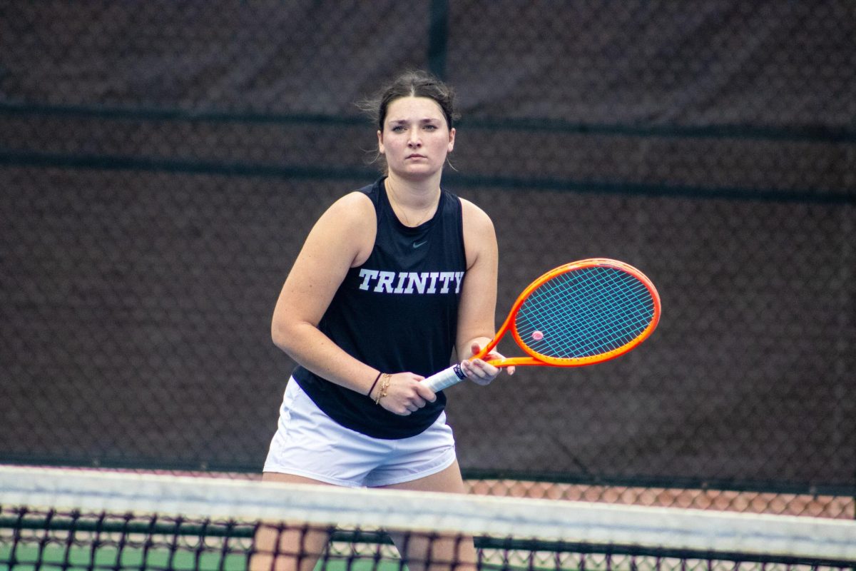 Sophomore Katie Schmidt grips her racket, eyes fixed on the next shot on Feb. 14 at the Butch Newman Tennis Center.