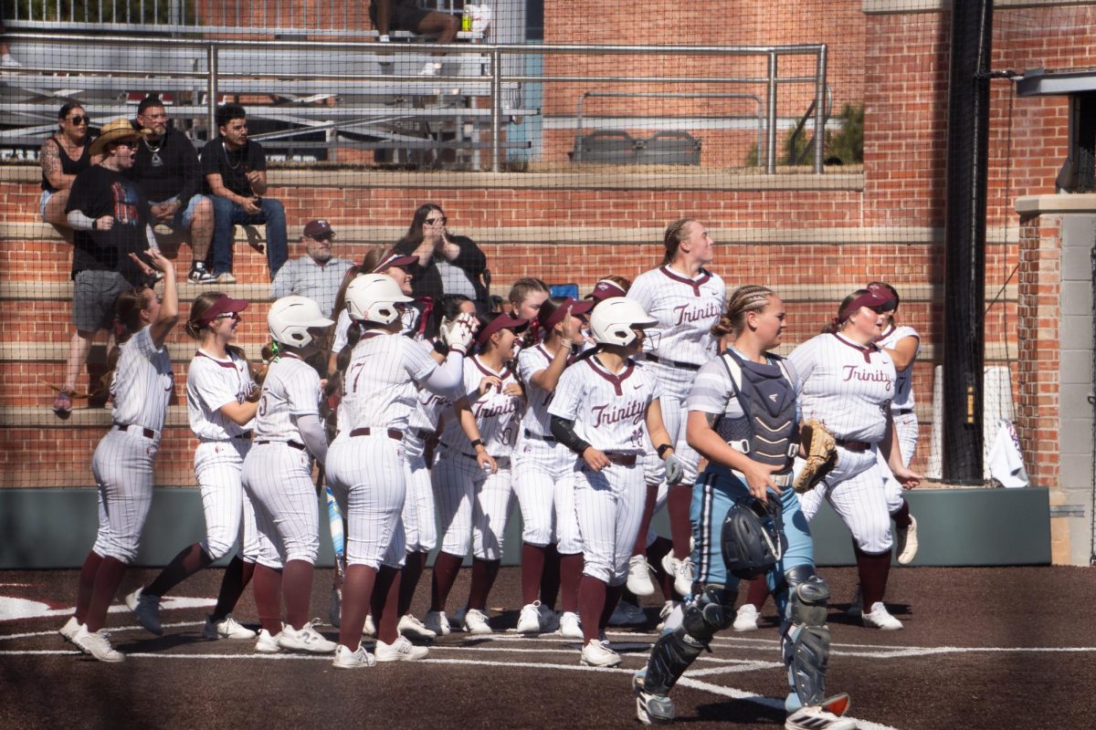 The Trinity U Tigers cheer as Sophomore Carsyn Lee finishes her homerun celebration against Coastal Bend on February 7th.