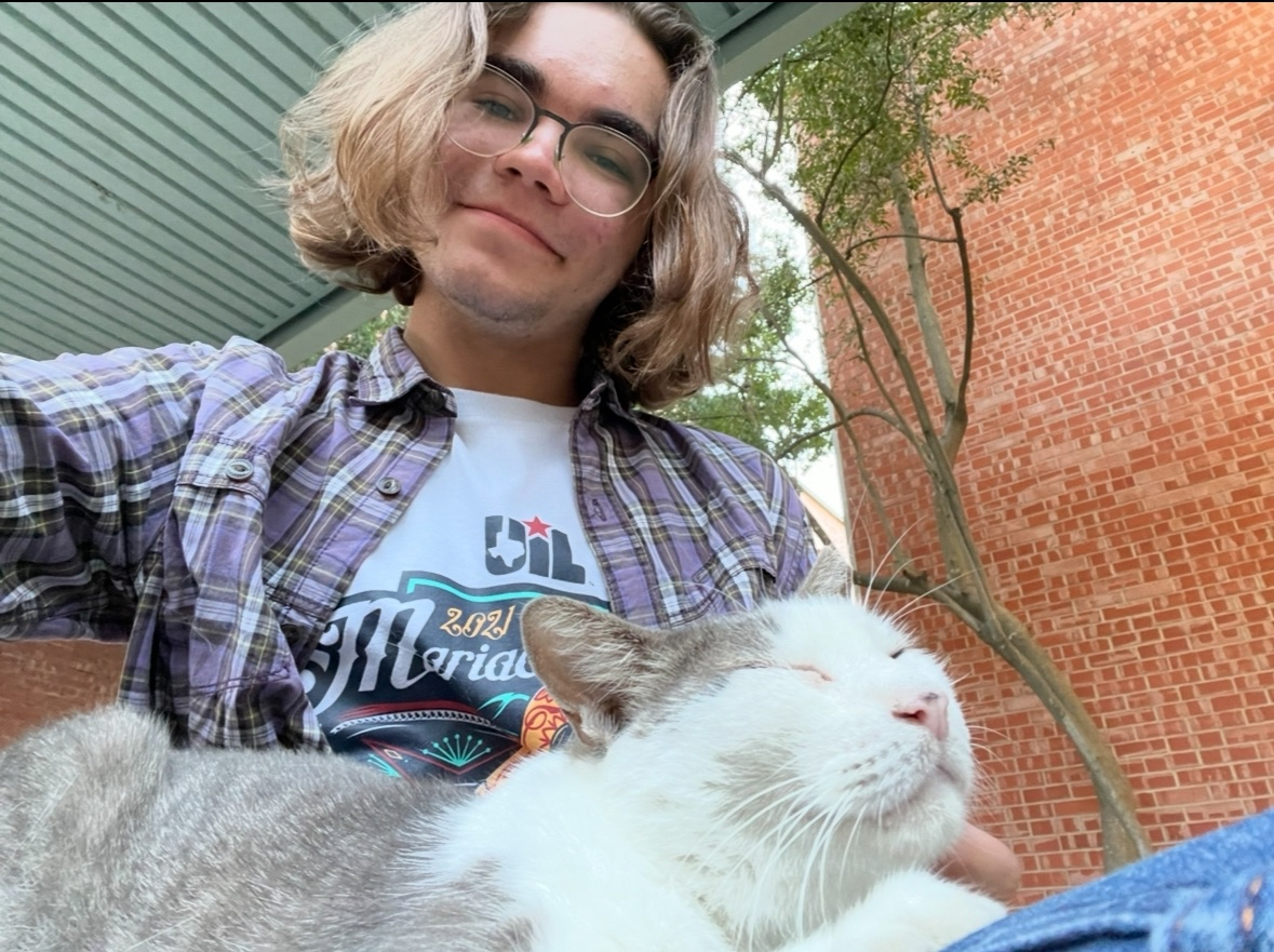 First-year Seven Aguirre spending time with Trinity, a Trinicat who died in 2024.
