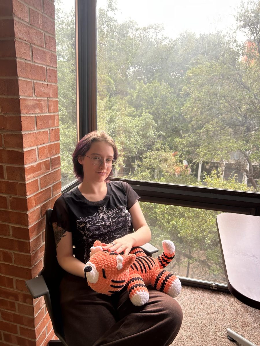 Anakin Becker holds their raffle prize, a crocheted tiger.