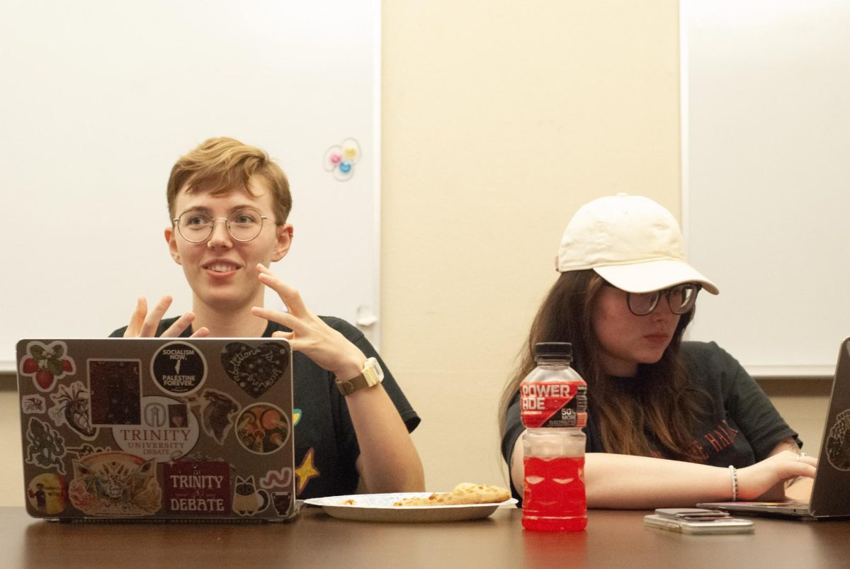 Patterson and King talk strategy at a debate meeting.