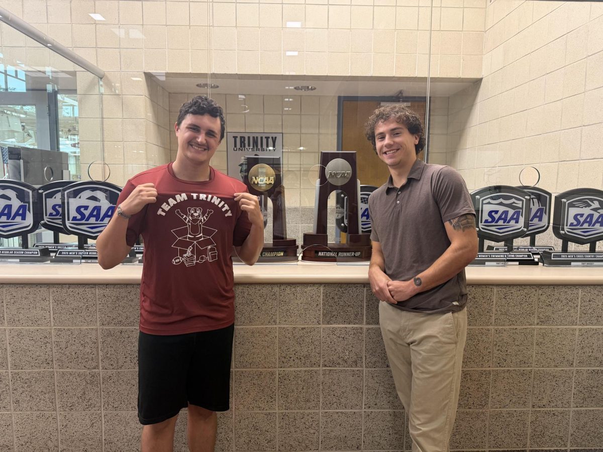 COLE ISAACSON and SCOTT LEBO with the trophies in the Bell Athletic Center.