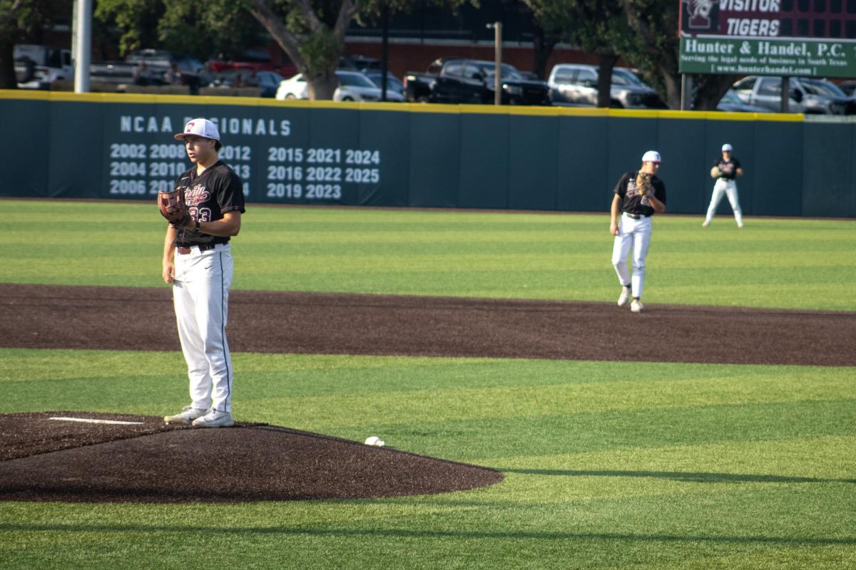 Sophomore Paul Nathanson (left) pauses on the mound before a pitch as sophomore John Ramsey (center) and graduate student Michael Lustina (right) watch during play at the baseball field at Trinity University on April 24, 2026.