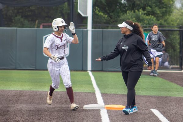 Senior Angela Baltzell shakes hands with assistant softball coach Jazmyne Cortinas at the softball field at Trinity University on April 18, 2026.