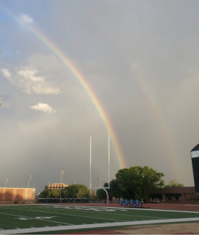 A rainbow setting over the Trinity University Stadium football field.